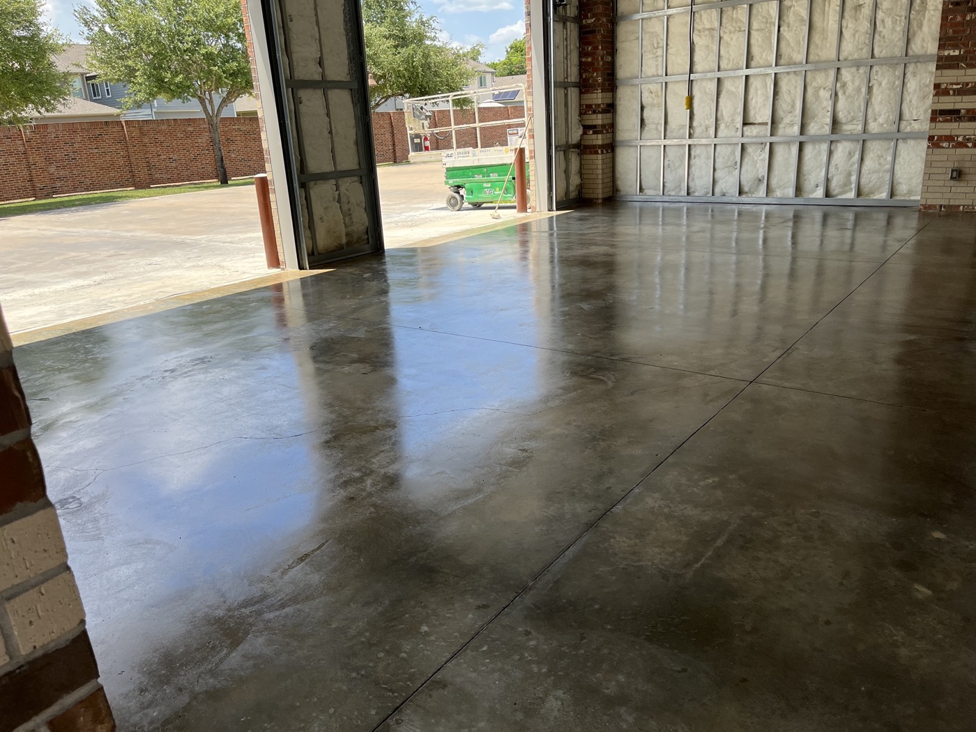 Finished fire station floor viewed toward the open apparatus bay doors