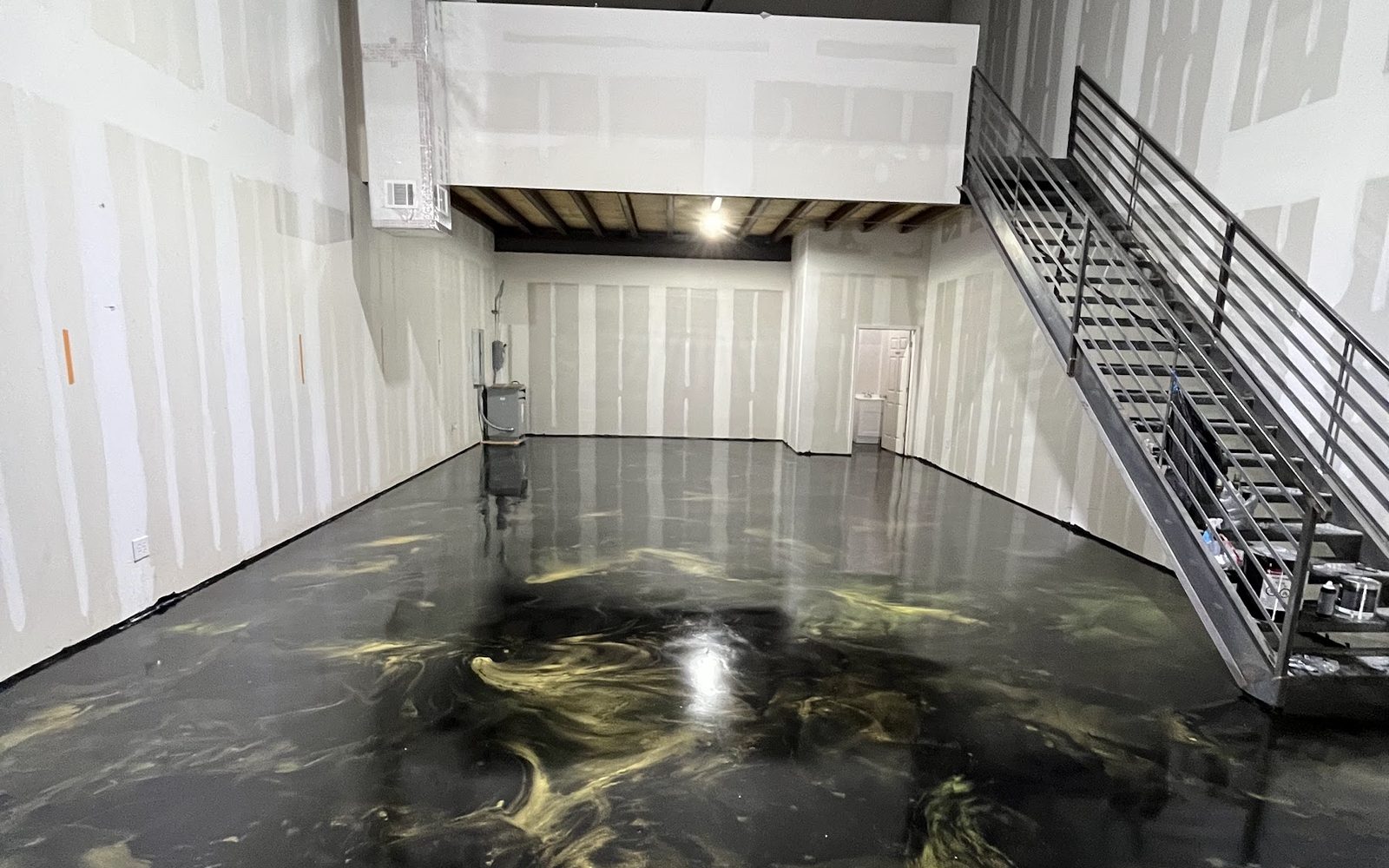 Gold and black metallic floor installed by Astro Epoxy at Hugo Studio
