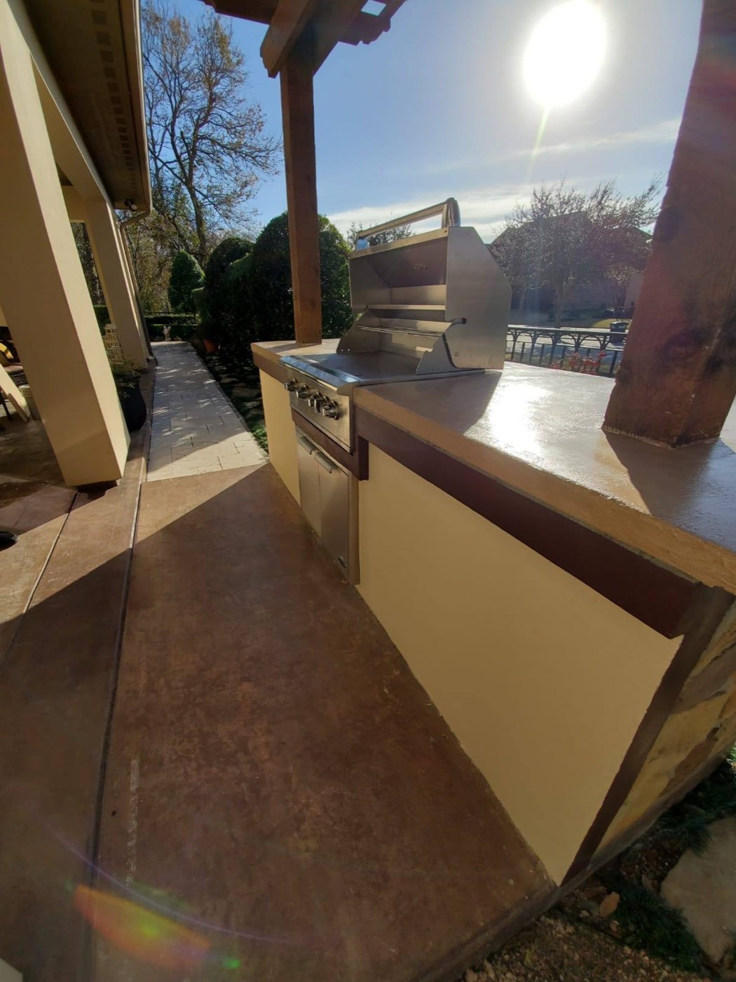 Close view of the sealed concrete countertop beside the built-in stainless grill