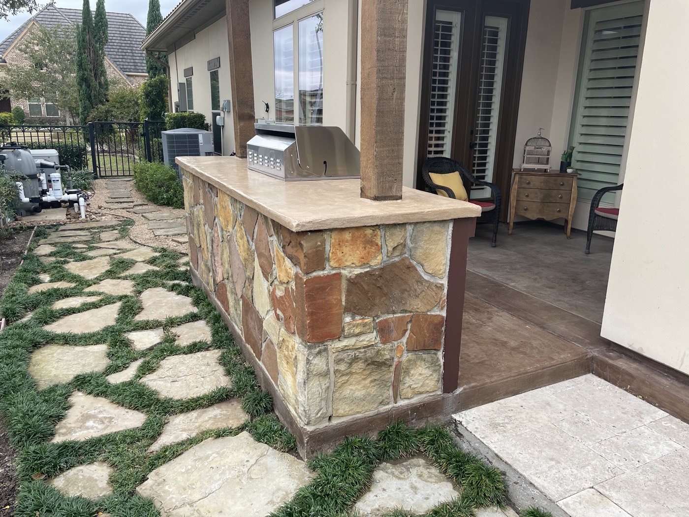 Wide view of the finished custom concrete countertop and stone outdoor kitchen