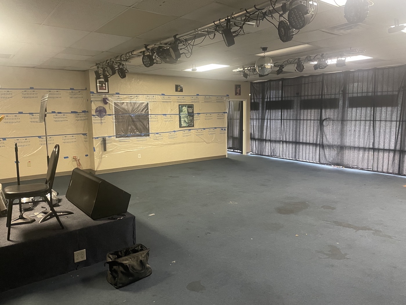 Rat's Music Studio before flooring removal, with the original dark floor covering in place